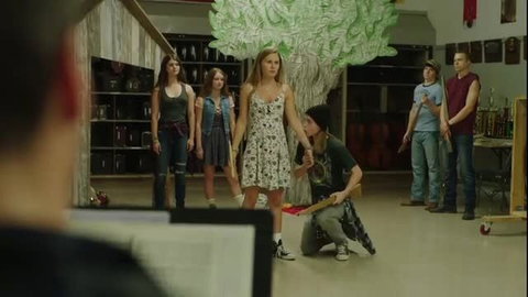 Teen girls in floral dress and tank tops with guys in school play scene