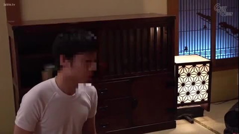 Man hiding behind a cabinet