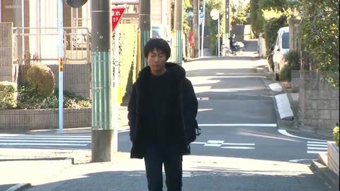 Japanese man in black hoodie walking urban street, Satsuki Mei brother inc