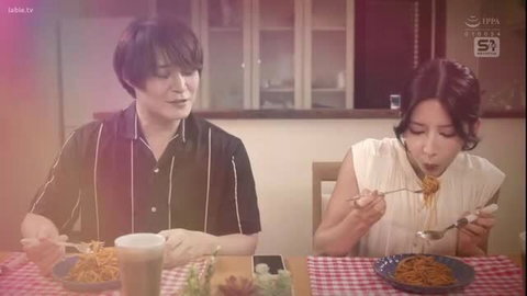 Asian JAV couple eating spaghetti intimately at table