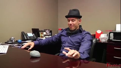 Man in fedora and shirt at desk with gray mouse, office tease
