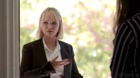 Lilly Bell in suit talks to Gizelle Blanco at door Girlsway scene