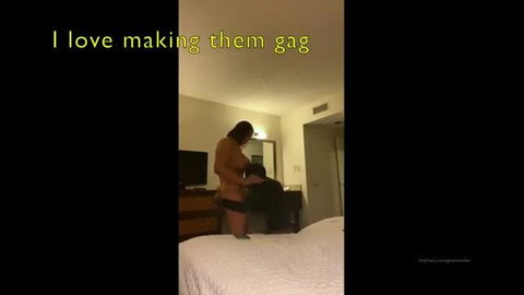 Busty Latina tranny stands over kneeling black guy in hotel room BJ