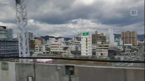 Japanese city skyline over train tracks under cloudy sky, Jable.tv