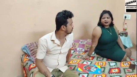 Curvy Desi Bhabhi in green dress sits with neighbor on bed