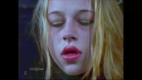 Blonde Insex model closeup with glossy lips, heavy eyes in live feed