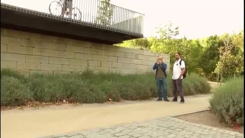 Spanish beauty on bike balcony, men watch in public tease