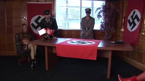 Hot blonde in Nazi uniform at officer's desk in steamy WW2 fetish scene