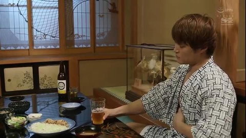 Japanese man in yukata drinking beer at table, JAV scene