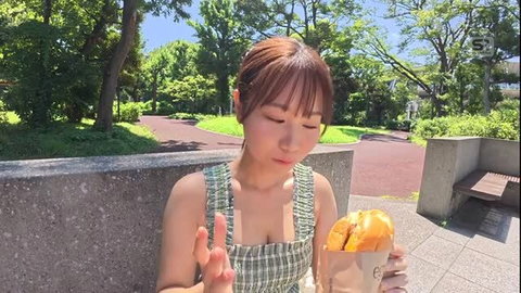 Cute Japanese college girl Natsuno in checkered sundress eating burger outdoors