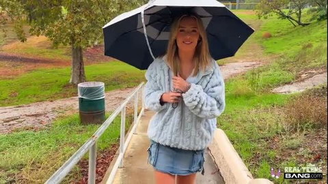 Ashlyn Angel in fuzzy cardigan and denim mini skirt with umbrella outdoors