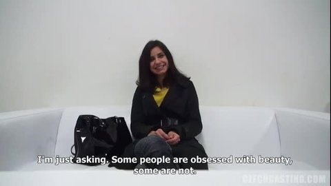 Renata 7727 smiling in black coat and yellow top casting interview