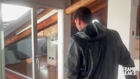 Man in black hoodie at door in steamy Italian home interior