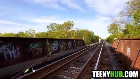Harley King on graffiti-covered train bridge outdoors