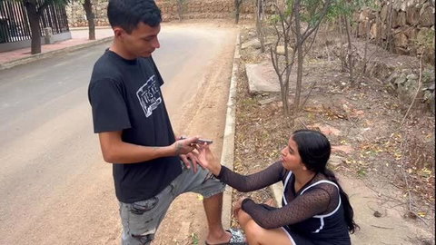 Indian teen Hilary Palvin kneels getting ring from guy outdoors