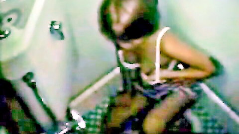 Slim Asian girl masturbating in lingerie and stockings on toilet