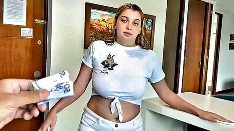Hot blonde in tight white crop top and shorts takes cash from hand at hotel desk
