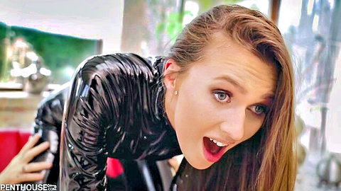 Stacy Cruz in tight black latex catsuit, on all fours with surprised expression
