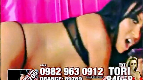 Ebony babe Tori with huge tits lies sideways exposing shaved pussy and fat ass in black thong