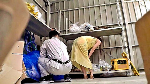Asian woman in yellow dress bends over shelves as man squats behind her in JAV