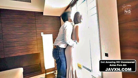 Japanese stepsister in white dress hugged by man from behind at home