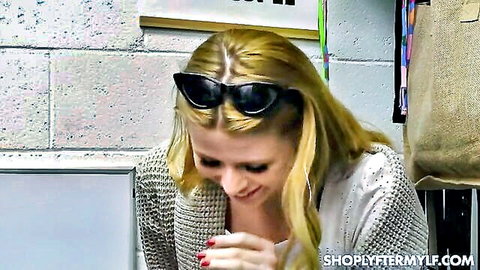 Blonde MILF Sahara Skye smiling in shoplifting tease scene