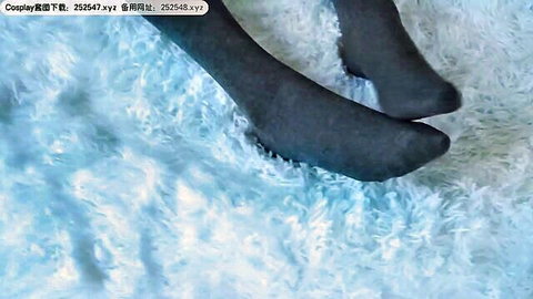 Woman's legs in sheer black stockings on white fluffy surface, teasing pose