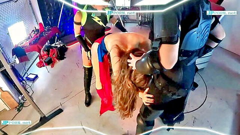 Redhead Supergirl cosplay captured by villains in dominatrix restraint scene