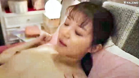 Asian woman topless on bed, aroused expression, eyes closed