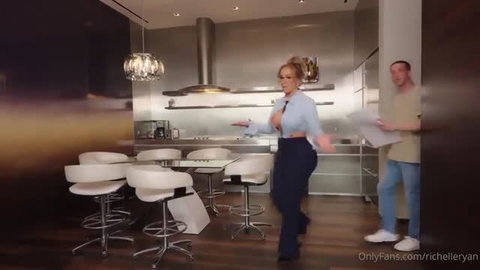 Richelle Ryan teases in unbuttoned blouse and tight pants in kitchen