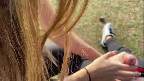 Blonde girl giving public blowjob in park, handjob closeup
