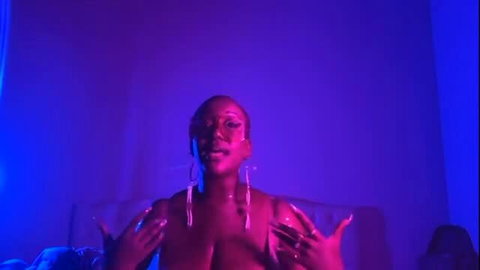 KING poses topless with big tits, nails up in purple neon light