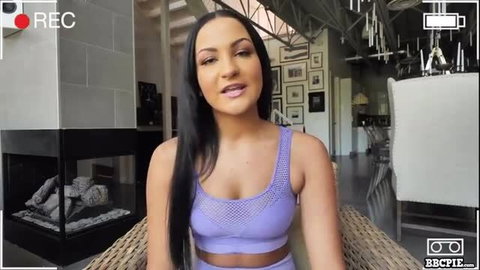 Hot Latina in sheer purple sports bra smiling seductively
