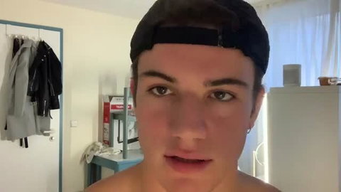 Hot young guy in cap taunts shirtless in messy spunk solo chat