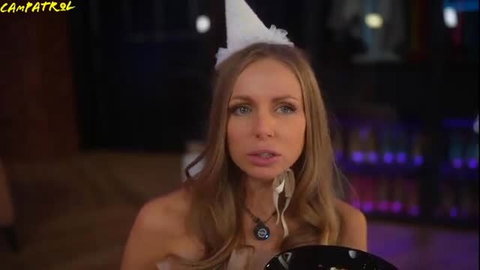 Russian MILF in party hat and sheer top, seductive pose