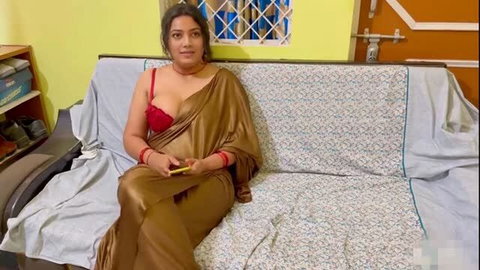 Hot Indian bhabi in gold saree and red bra, deep cleavage tease