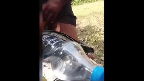 Desi man inserting bottle in woman's pussy outdoors amateur sex