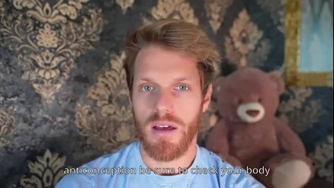 Blond bearded man in blue shirt talks contraception with teddy bear