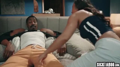 Isiah Maxwell lounges as woman flirts by groping his crotch in orange sweats