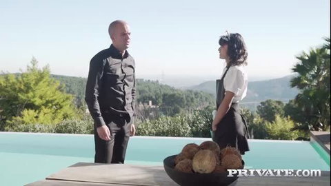 Bald man talks to sexy Latina maid in apron by pool