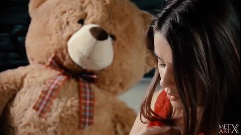 Beautiful brunette cuddles giant teddy bear naked at home