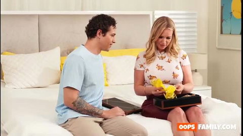 Rachael Cavalli blonde MILF in skirt with gift on bed