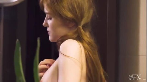 Nude ginger babe with perky tits poses playfully in steamy bathroom