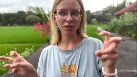 Blonde babe in glasses gesturing outdoors on Bali, AI girlfriend vlog tease