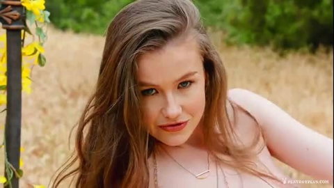 Nude all-natural brunette poses topless outdoors with big tits and wet-look hair