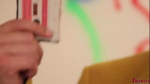 Hand holding sticky cum-covered cassette tape in Manager's Sticky Surprise
