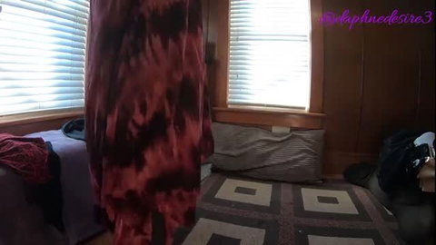 Daphne dancing in tie-dye dress by sunlit windows