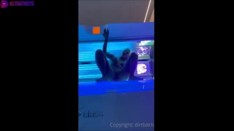 Inked busty Danish blonde in tanning bed, nude pose