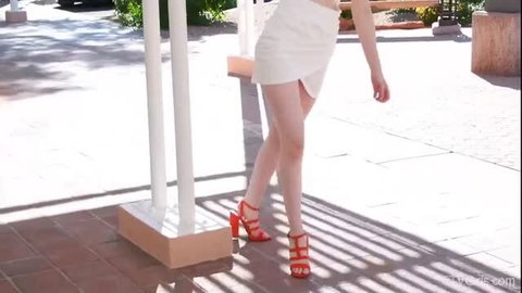 Gorgeous Giulia walks in tiny white skirt and red heels, softcore tease