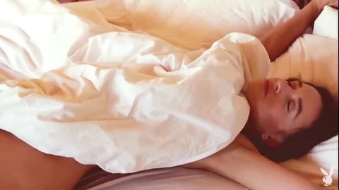 Sexy brunette wakes up naked showing hot body curves in bed